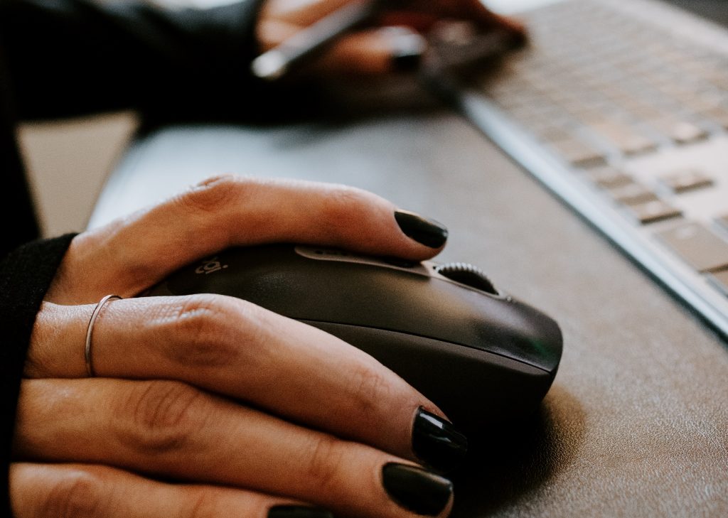 Hand clicking a computer mouse